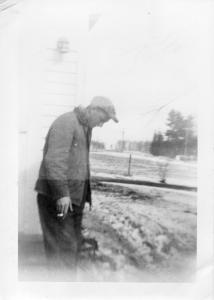 George Behselich standing on front porch steps lat